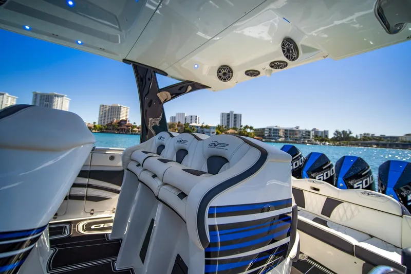 Slide: The Image of Luxury MTI V42 boat interior with modern seating, overlooking waterfront cityscape, 2024 model. - 10