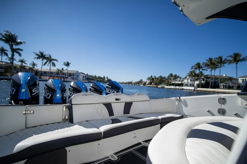 Slide: The Image of 2024 MTI V42 boat with powerful engines, luxurious seating, and scenic waterfront view. - 11