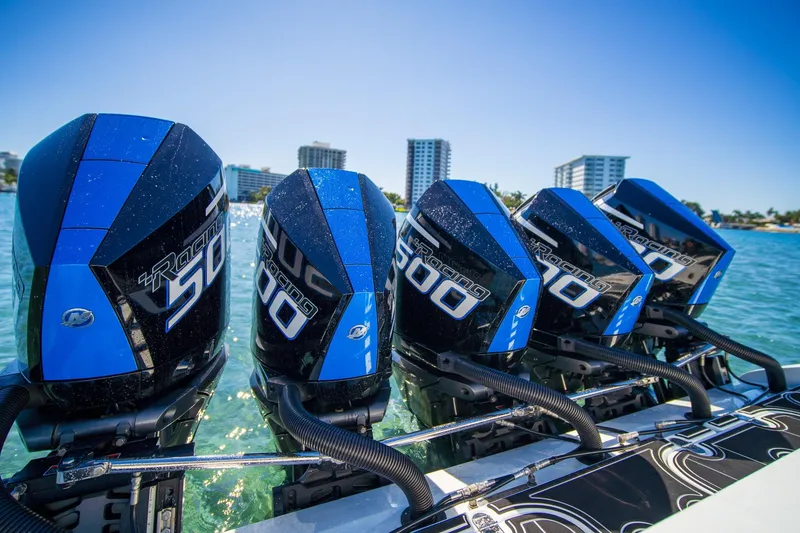 Slide: The Image of Four powerful outboard motors on a 2024 MTI V42 boat, with a cityscape backdrop. - 13