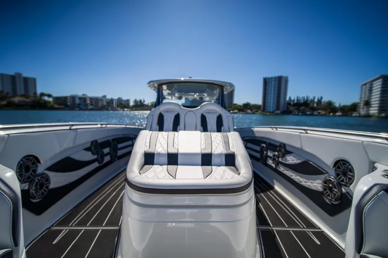 Slide: The Image of 2024 MTI V42 luxury boat interior with sleek seating and waterfront view. - 15