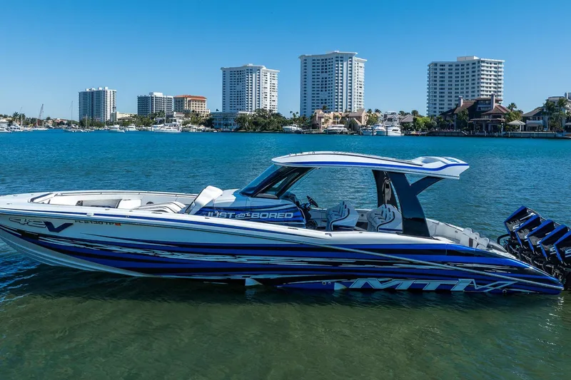 Slide: The Image of 2024 MTI V42 boat on water with city skyline in background. - 3