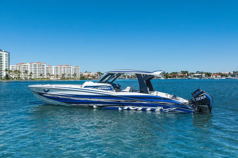 Slide: The Image of 2024 MTI V42 boat on clear blue water with cityscape background. - 4