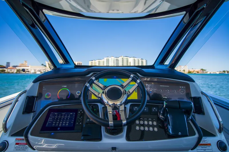 Slide: The Image of Cockpit view of 2024 MTI V42 boat with advanced navigation system and steering wheel. - 7