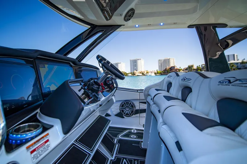 Slide: The Image of Interior of 2024 MTI V42 boat with modern dashboard and luxury seating. - 8