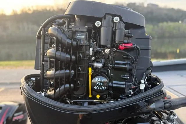 Slide: The Image of 2023 Vexus ADX 190 boat engine, detailed view, outdoors near a lake. - 13