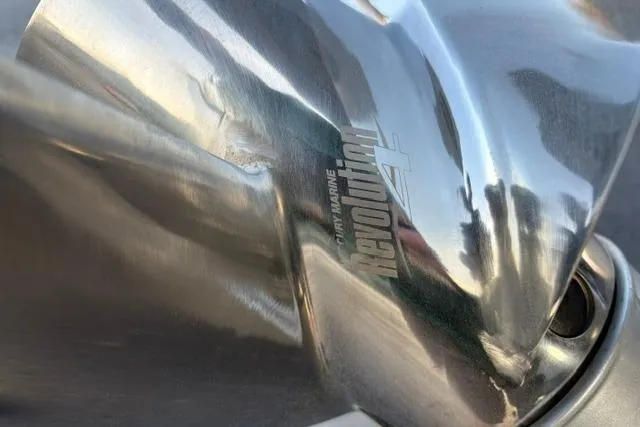 Slide: The Image of Close-up of a damaged stainless steel boat propeller, featuring the "Revolution 4" branding. - 18