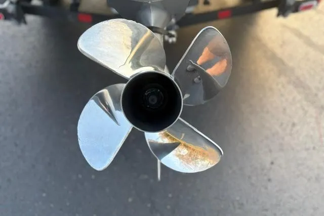 Slide: The Image of Close-up of a 2023 Vexus ADX 190 boat propeller on pavement. - 19