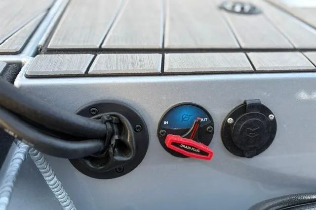 Slide: The Image of Control panel of 2023 Vexus ADX 190 boat with drain plug and connectors. - 21