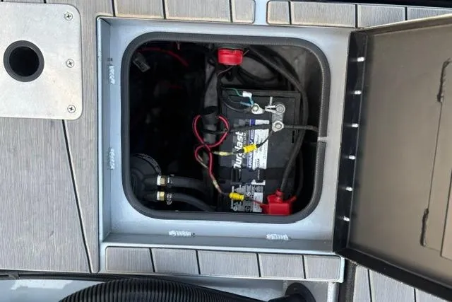 Slide: The Image of Battery compartment of 2023 Vexus ADX 190 boat, showing wiring and connections. - 24