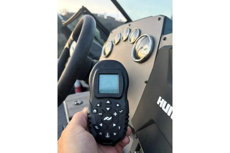 Slide: The Image of Hand holding remote control in Vexus ADX 190 boat cockpit, 2023 model. - 25