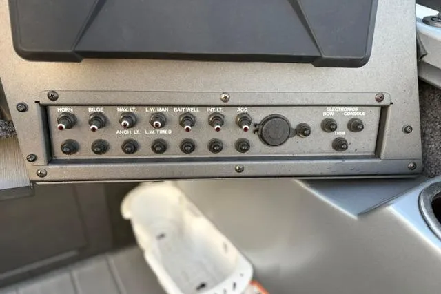 Slide: The Image of Control panel of a 2023 Vexus ADX 190 boat with various switches and labels. - 33
