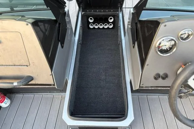 Slide: The Image of 2023 Vexus ADX 190 boat interior with rod storage compartment and dashboard view. - 37