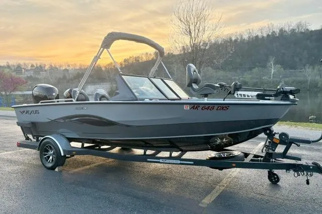 Slide: The Image of 2023 Vexus ADX 190 boat on trailer at sunset by a lake. - 4