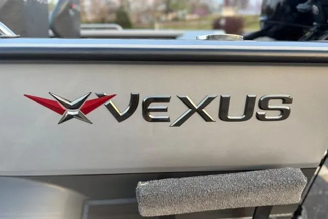 Slide: The Image of 2023 Vexus ADX 190 boat logo on metallic surface. - 51