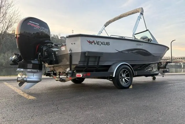 Slide: The Image of 2023 Vexus ADX 190 boat with Mercury engine on trailer, parked outdoors. - 6