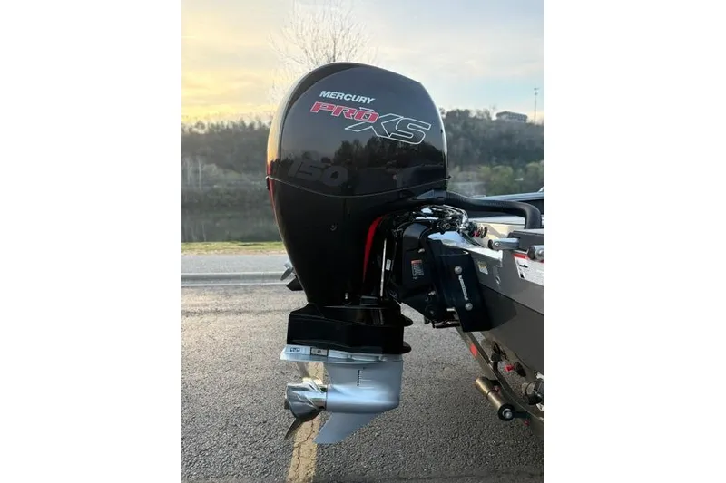 Slide: The Image of 2023 Vexus ADX 190 with Mercury Pro XS outboard motor, parked by a scenic lake. - 7