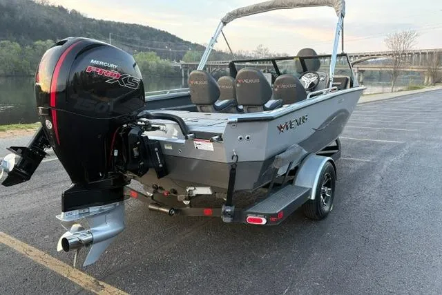 Slide: The Image of 2023 Vexus ADX 190 boat with Mercury Pro XS engine, parked near a scenic river. - 8