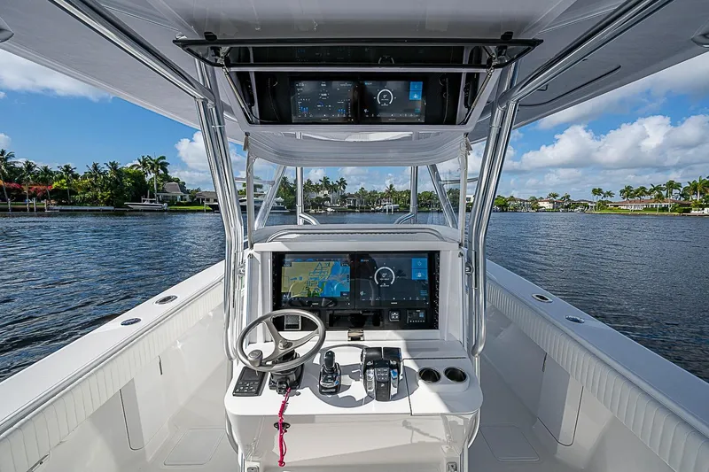 Slide: The Image of 2022 Bahama 41 boat cockpit with advanced navigation system on a sunny day. - 10