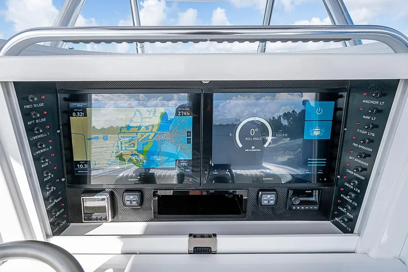 Slide: The Image of 2022 Bahama 41 boat dashboard with dual Garmin displays and control panel. - 12
