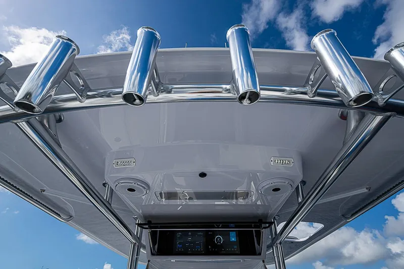 Slide: The Image of 2022 Bahama 41 boat with stainless steel rod holders and electronics, under a blue sky. - 15