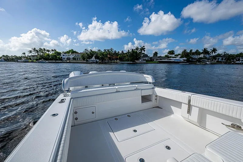 Slide: The Image of 2022 Bahama 41 boat on water with scenic waterfront view and blue sky. - 20