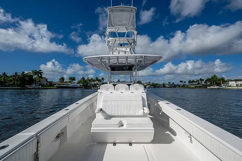 Slide: The Image of 2022 Bahama 41 boat on water, clear sky, luxurious seating, and sleek design. - 21