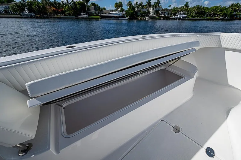 Slide: The Image of 2022 Bahama 41 boat with open storage compartment on deck by the water. - 26