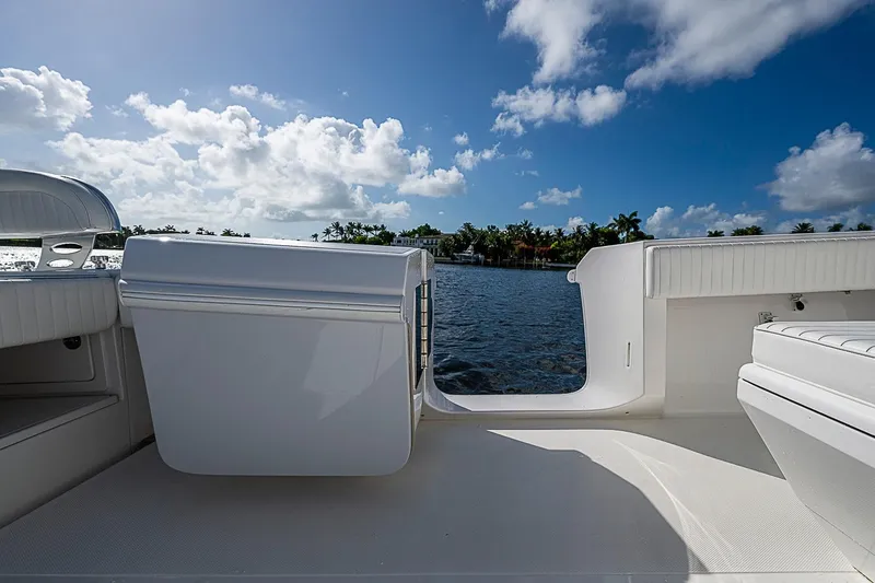 Slide: The Image of 2022 Bahama 41 boat deck with seating, overlooking serene water and blue sky. - 29