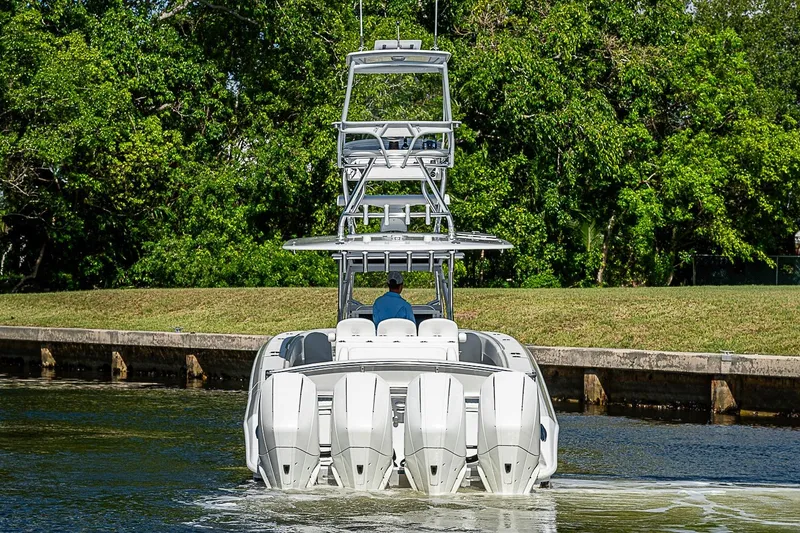 Slide: The Image of 2022 Bahama 41 boat with multiple engines cruising on a calm waterway. - 3