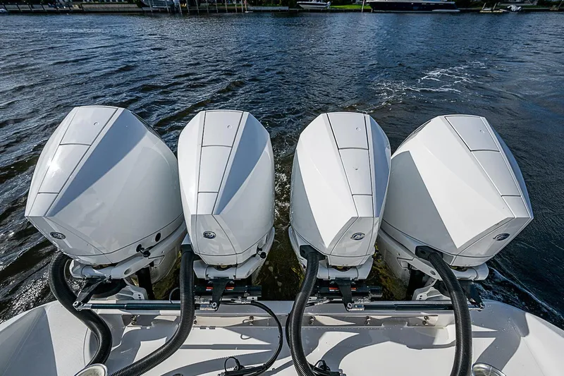 Slide: The Image of Four powerful outboard motors on a 2022 Bahama 41 boat, cruising on water. - 30