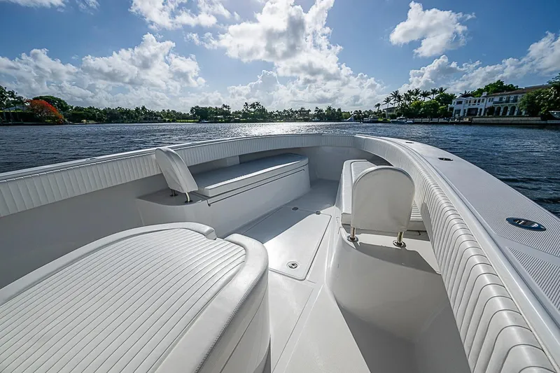 Slide: The Image of 2022 Bahama 41 boat interior with white seating, on a sunny day by the water. - 4