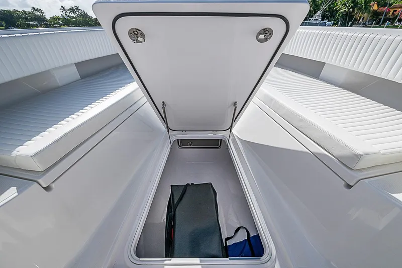 Slide: The Image of Open storage compartment on 2022 Bahama 41 boat with cushioned seating. - 5