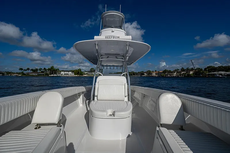 Slide: The Image of 2022 Bahama 41 boat with sleek white seating, cruising on a sunny day. - 8