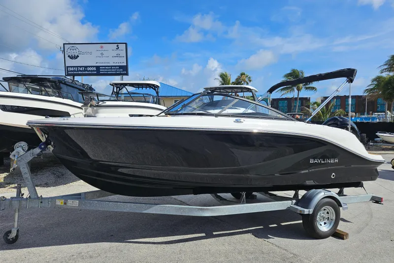 The Image of 2026 Bayliner V20 boat on trailer under clear blue sky. - 1
