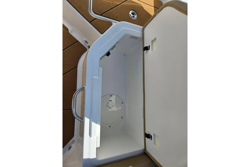 Slide: The Image of Open storage compartment on 2026 Bayliner V20 boat, featuring sleek design and ample space. - 11