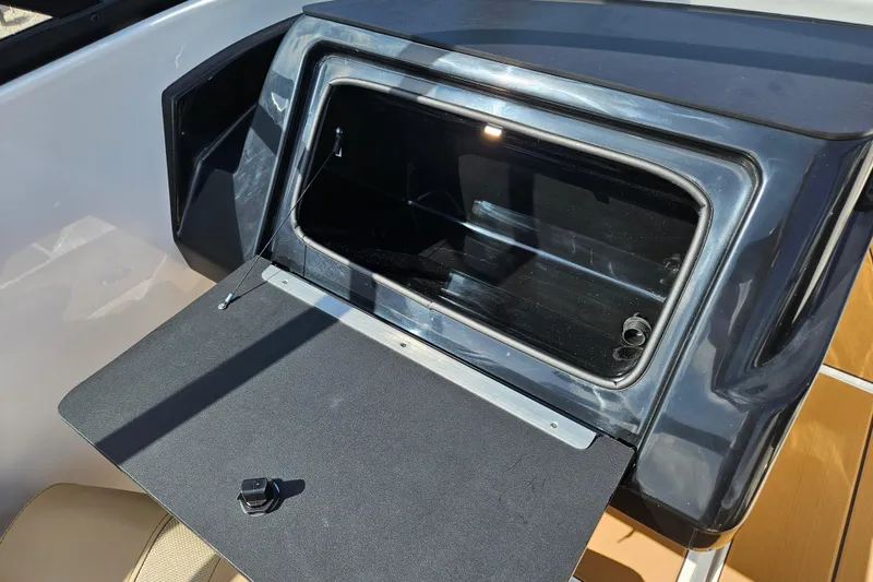 Slide: The Image of Open storage compartment on 2026 Bayliner V20 boat, featuring sleek design and modern finish. - 14