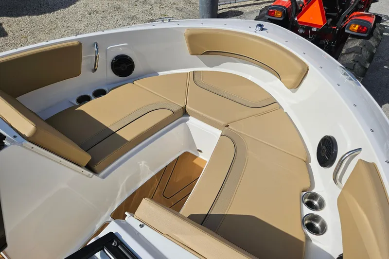 Slide: The Image of 2026 Bayliner V20 boat interior with tan seating and cup holders. - 15