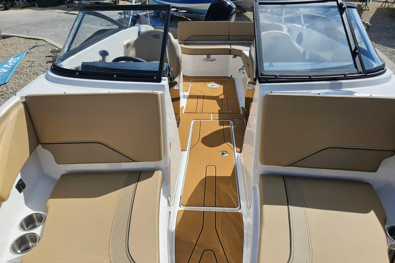 Slide: The Image of 2026 Bayliner V20 boat interior with tan seating and sleek design. - 16