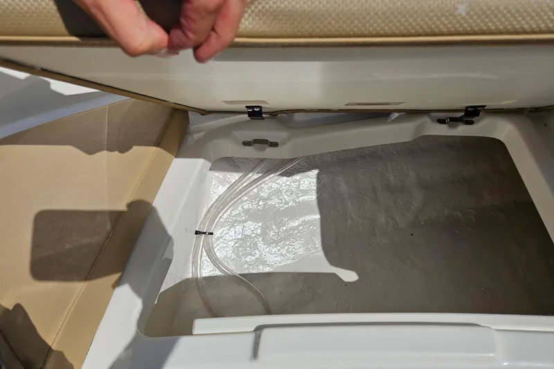 Slide: The Image of Open storage compartment in 2026 Bayliner V20 boat, showcasing interior space and design. - 18