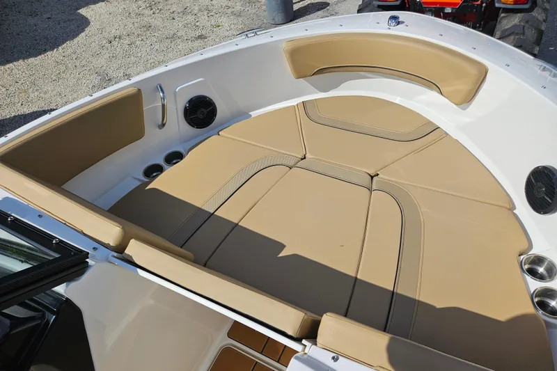 Slide: The Image of 2026 Bayliner V20 boat interior with tan cushioned seating and cup holders. - 20