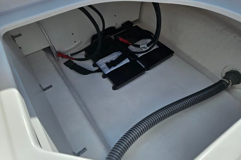 Slide: The Image of Battery compartment of 2026 Bayliner V20 boat with cables and hose. - 21