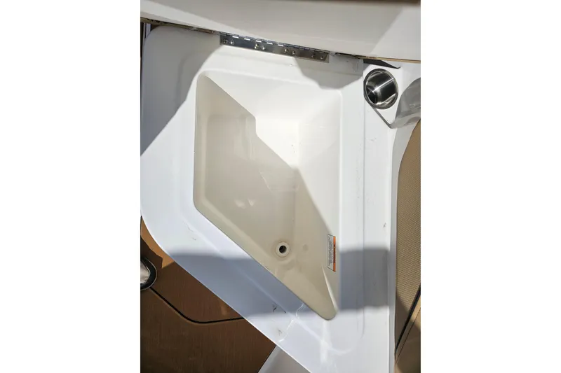 Slide: The Image of Bayliner V20 2026 boat sink with cup holder, white and beige interior. - 22