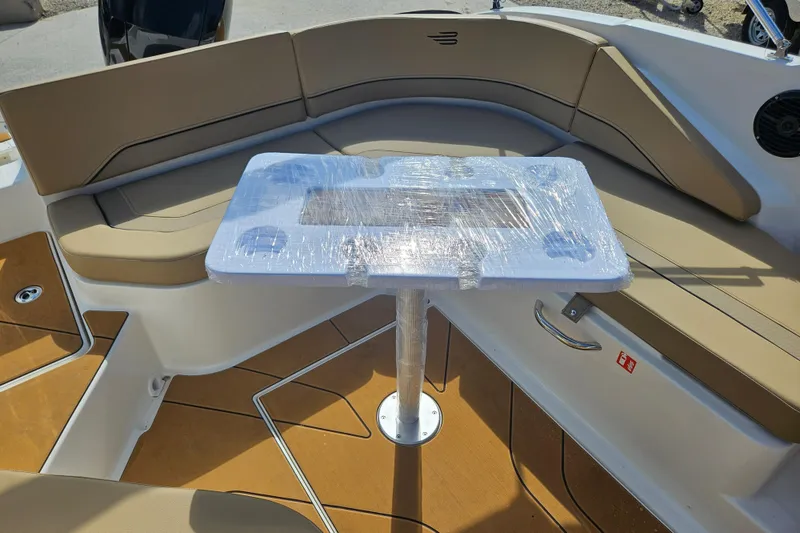 Slide: The Image of Interior of 2026 Bayliner V20 boat with wrapped table and cushioned seating. - 24