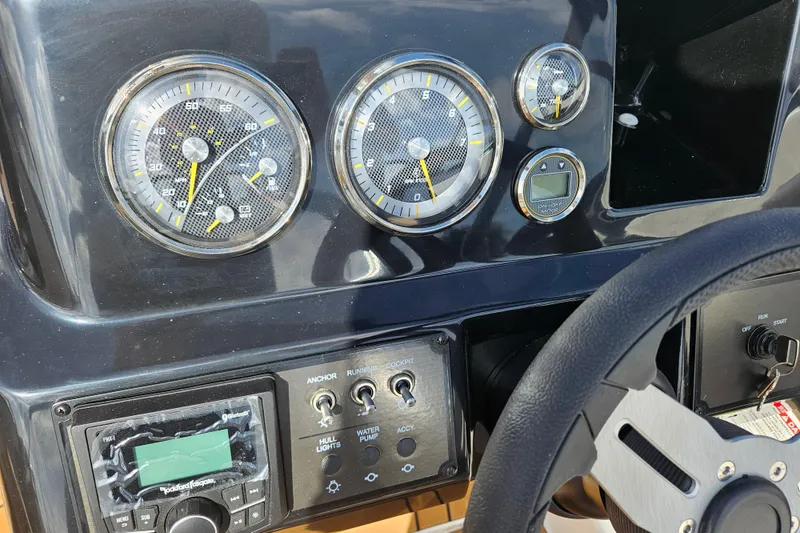 Slide: The Image of Dashboard of a 2026 Bayliner V20 boat with gauges and controls. - 25