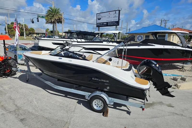 Slide: The Image of 2026 Bayliner V20 boat on trailer, displayed outdoors at a dealership. - 3