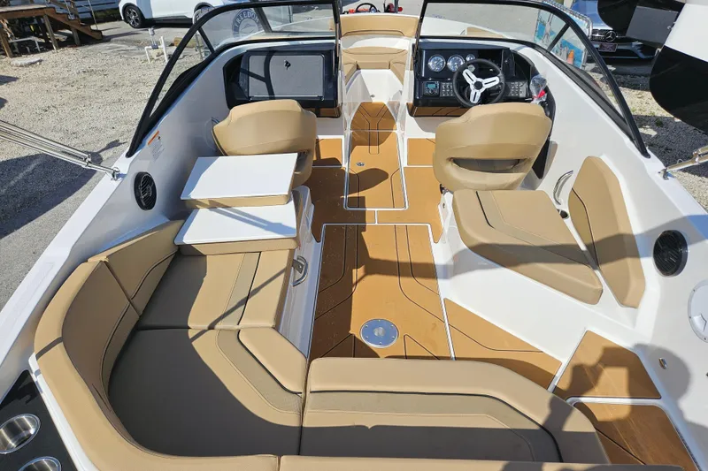 Slide: The Image of Interior view of 2026 Bayliner V20 boat with tan seating and modern dashboard. - 4