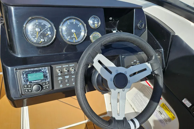Slide: The Image of Steering wheel and dashboard of 2026 Bayliner V20 boat with gauges and controls. - 5