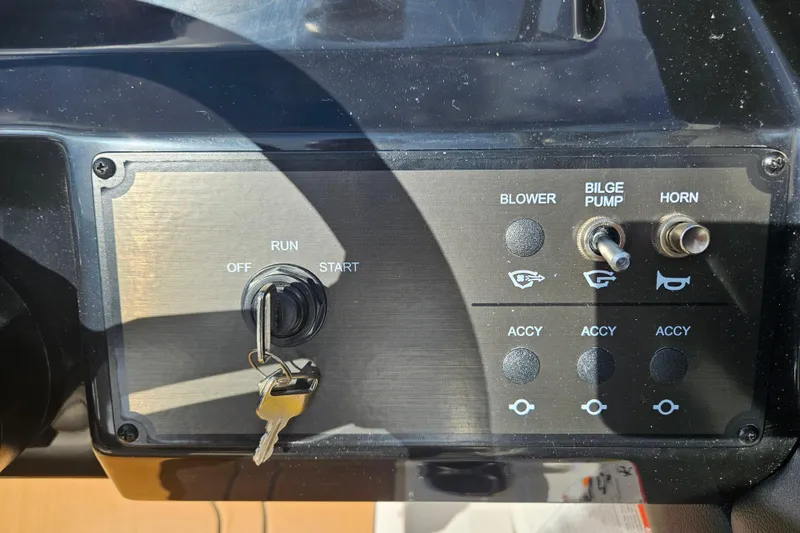 Slide: The Image of Control panel of a 2026 Bayliner V20 boat with ignition and switches. - 8