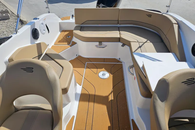 Slide: The Image of 2026 Bayliner V20 boat interior with tan seating and wood-style flooring. - 9