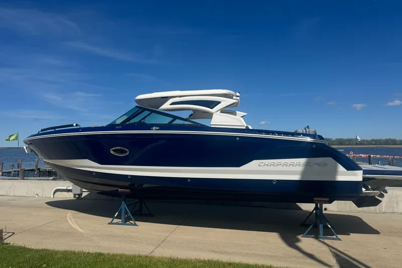 Slide: The Image of 2026 Chaparral SSX 30 boat on display by the waterfront under a clear blue sky. - 1